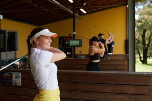 Ladies practicing golf driving range