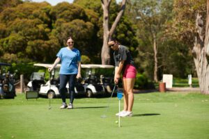 Ladies practicing golf putting