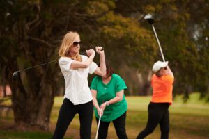 Ladies golf lesson lesson practicing hitting